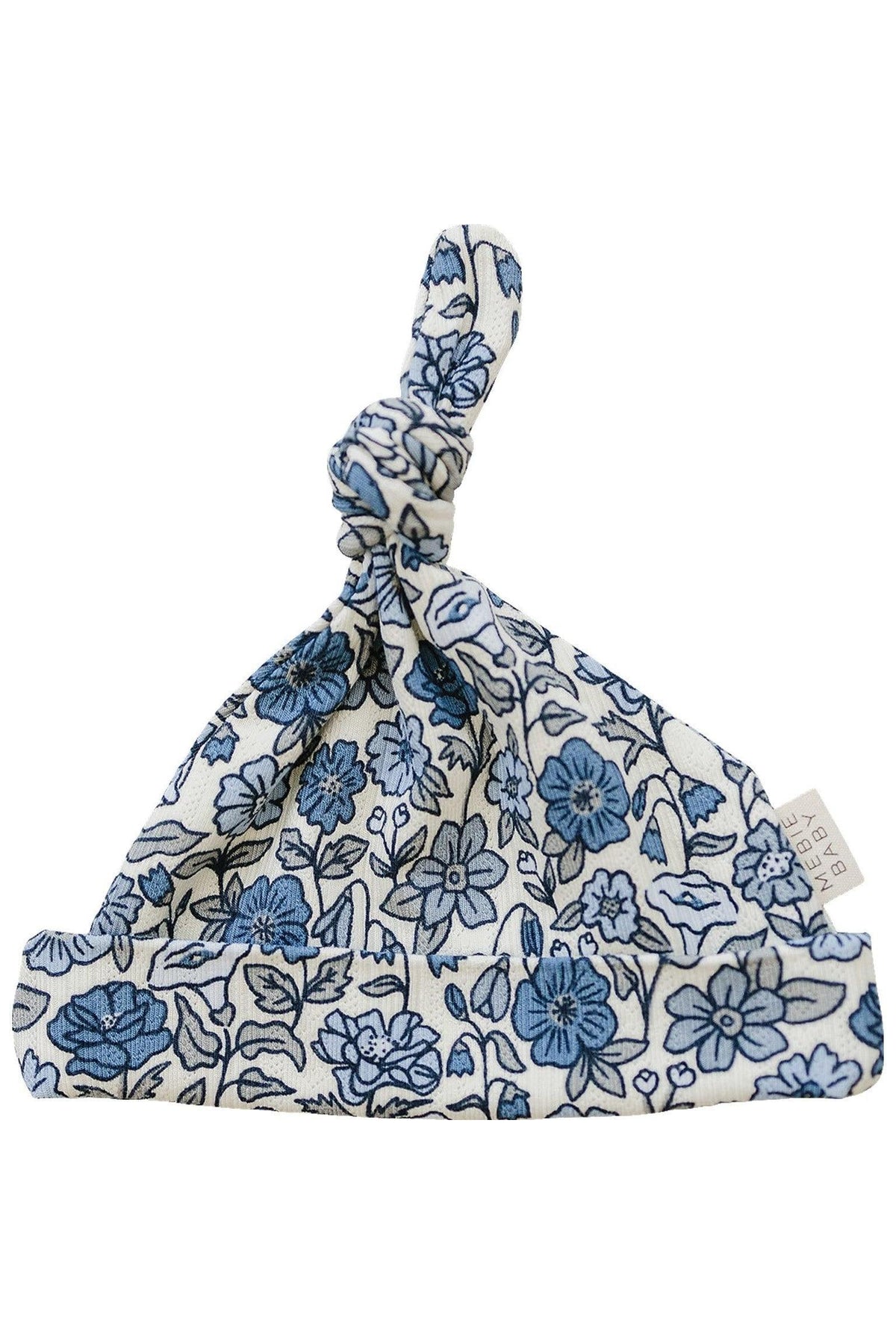 White newborn knot hat featuring a blue floral pattern, made from soft bamboo fabric, with a visible brand tag.