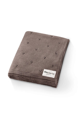 Brown pointelle knit swaddle blanket folded neatly with a Bleu-La-La Organics label, showcasing its organic cotton material.