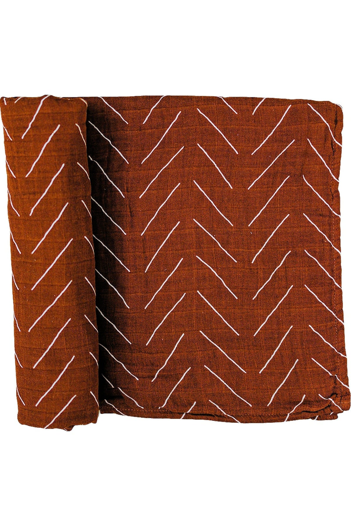 Rust-colored muslin swaddle blanket with white zigzag pattern, folded neatly. Made from 100% cotton.