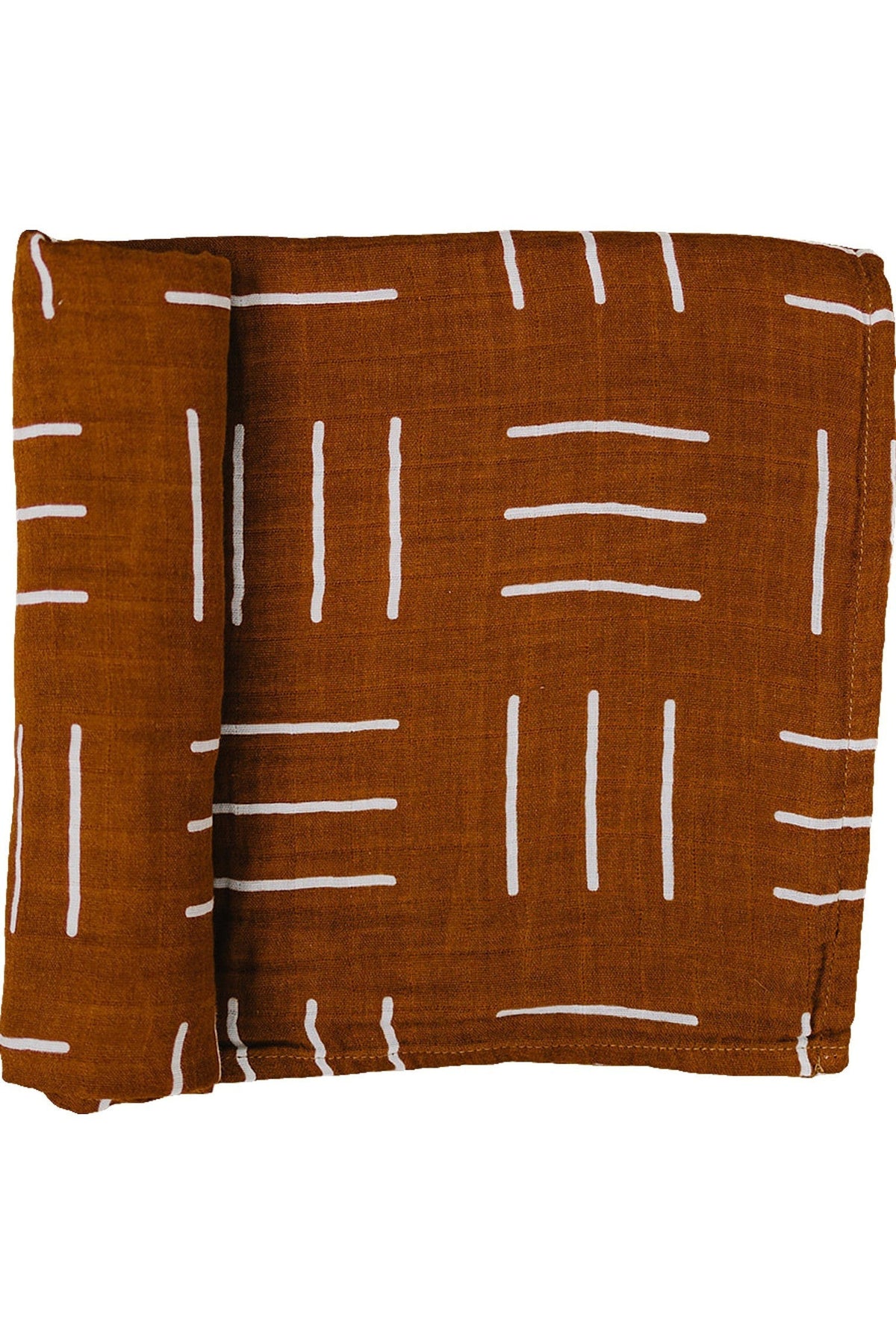 A folded mustard-colored muslin swaddle blanket with white mudcloth pattern, made from 100% cotton.