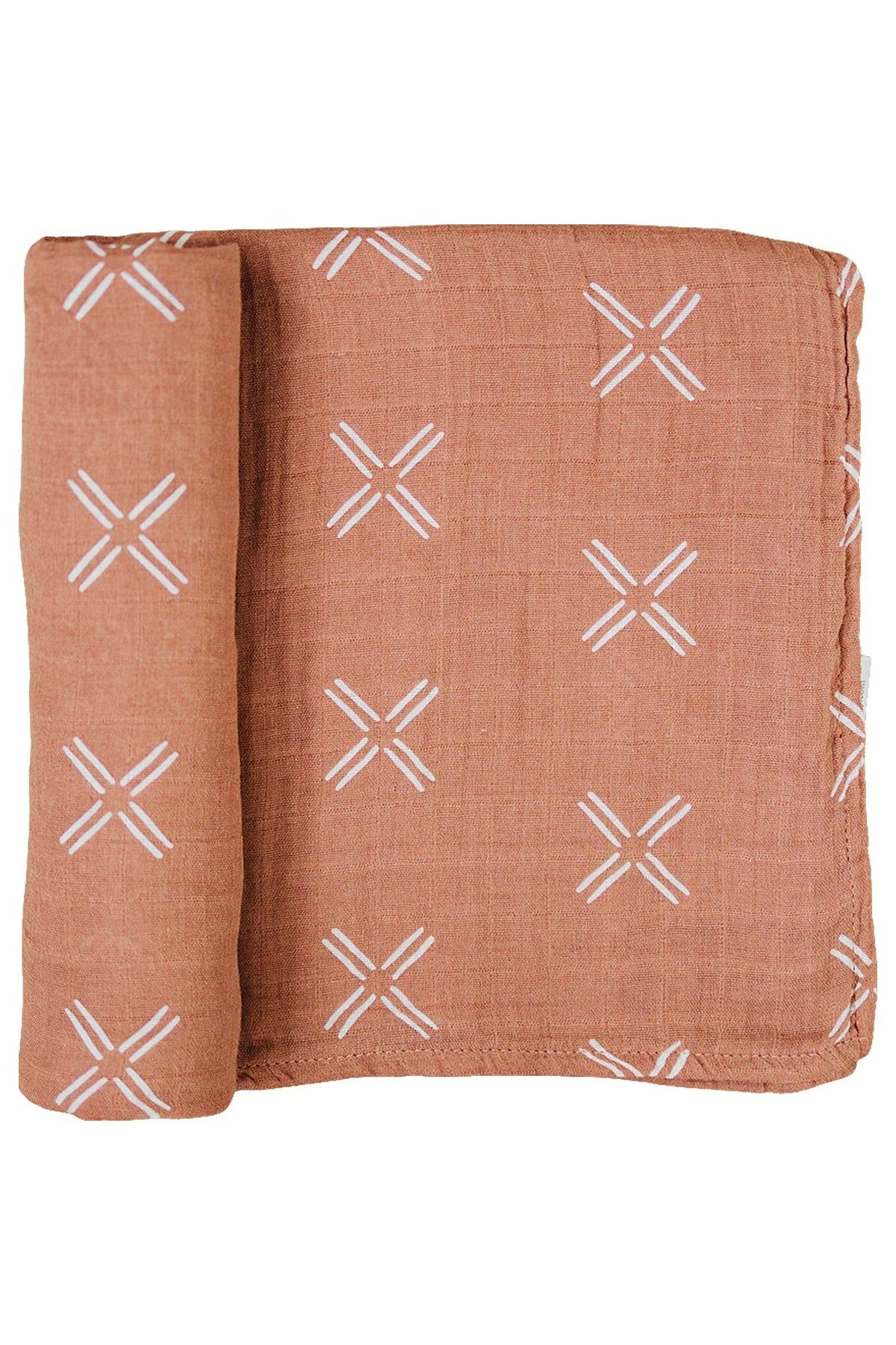 A folded terracotta muslin swaddle blanket with white geometric cross patterns made from 100% cotton fabric.