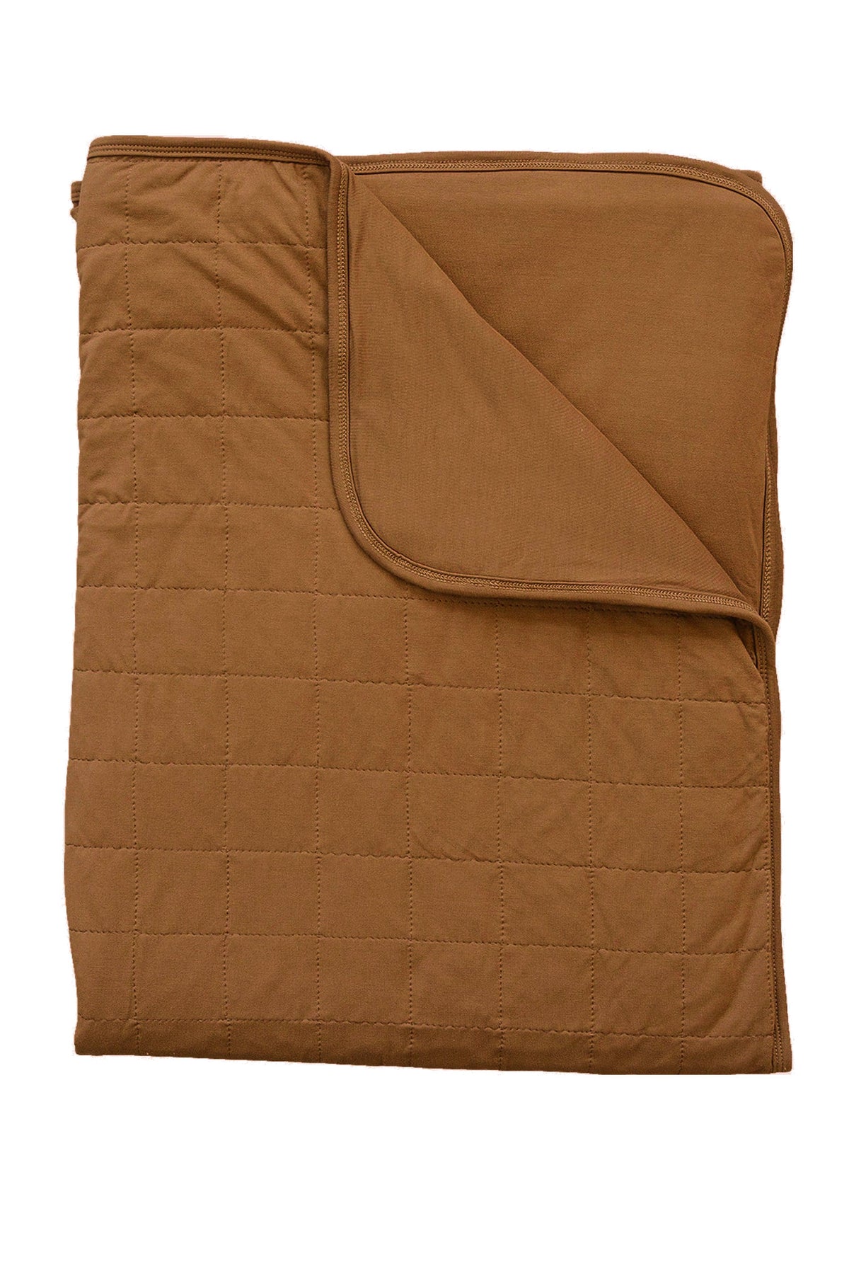 Mustard-colored quilt with visible stitching, folded to show both sides. Made from soft bamboo fabric.