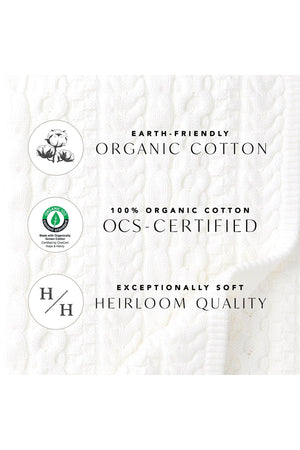 Close-up of a textured white fabric showcasing a cable knit pattern, with labels indicating it is made from 100% organic cotton and is OCS-certified for sustainability.
