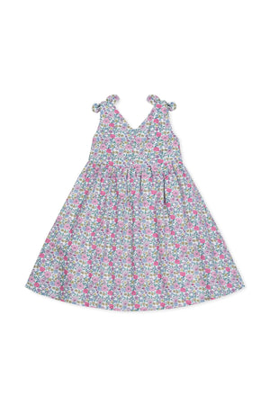 A floral linen dress for girls featuring bow shoulder straps, a v-neck silhouette, and a full skirt. Ideal for toddlers and kids, this dress combines comfort with a charming style.