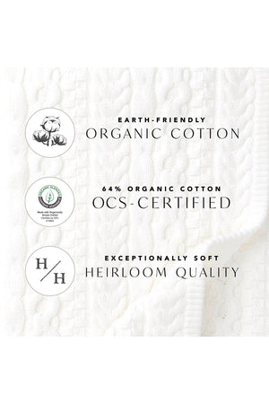 A textured white fabric featuring organic cotton branding, highlighting its exceptional softness and heirloom quality attributes.