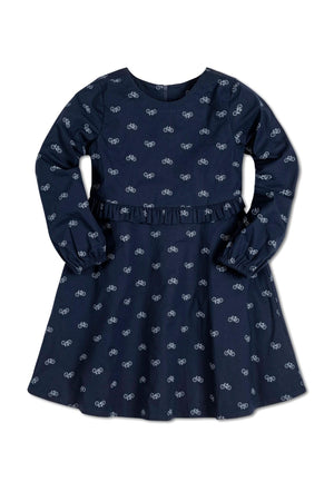 Navy long-sleeve dress featuring a bicycle print and a ruffle detail at the waist, made from organic cotton.