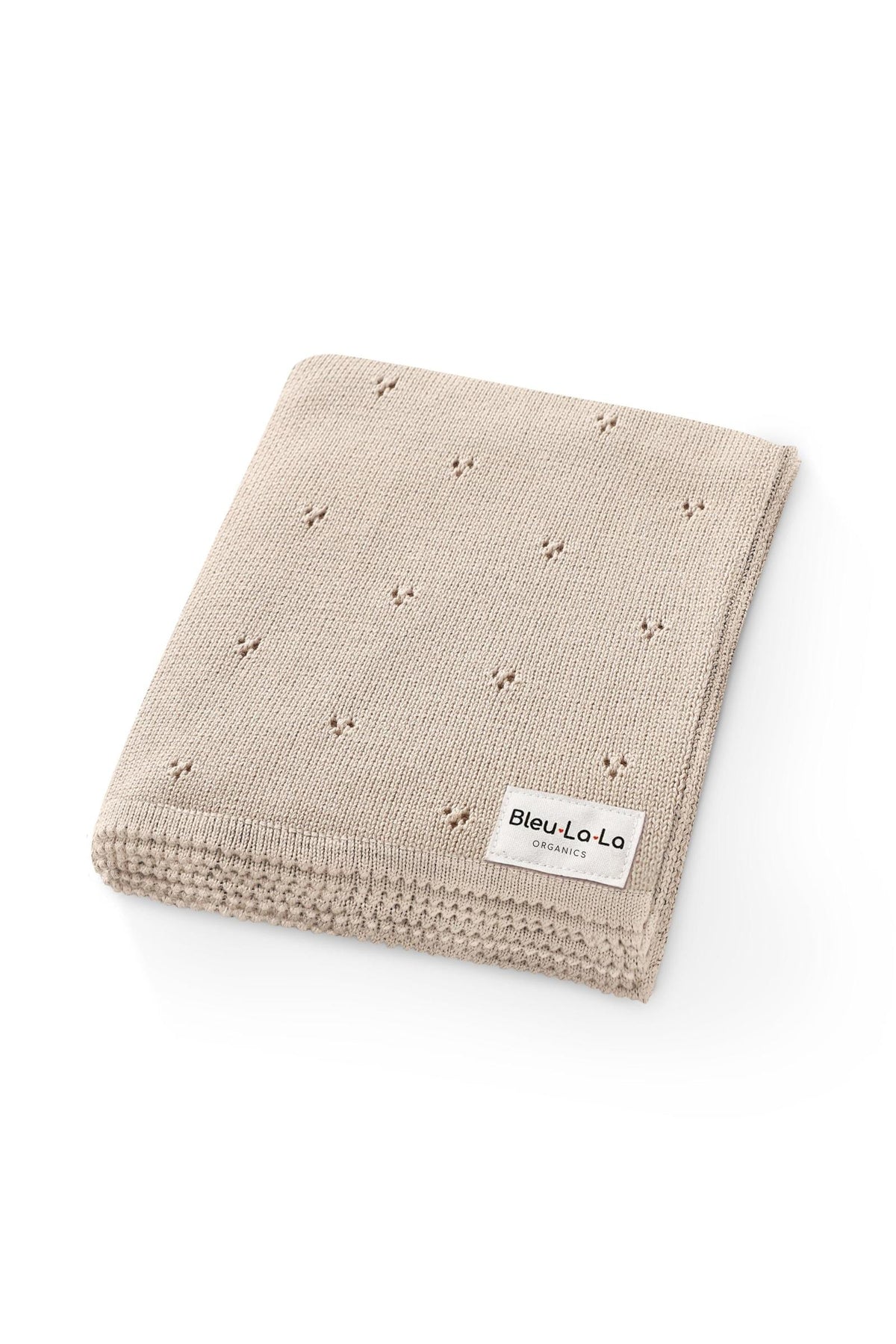 Beige knitted blanket with a pointelle pattern and a Bleu La La Organics label, folded neatly.
