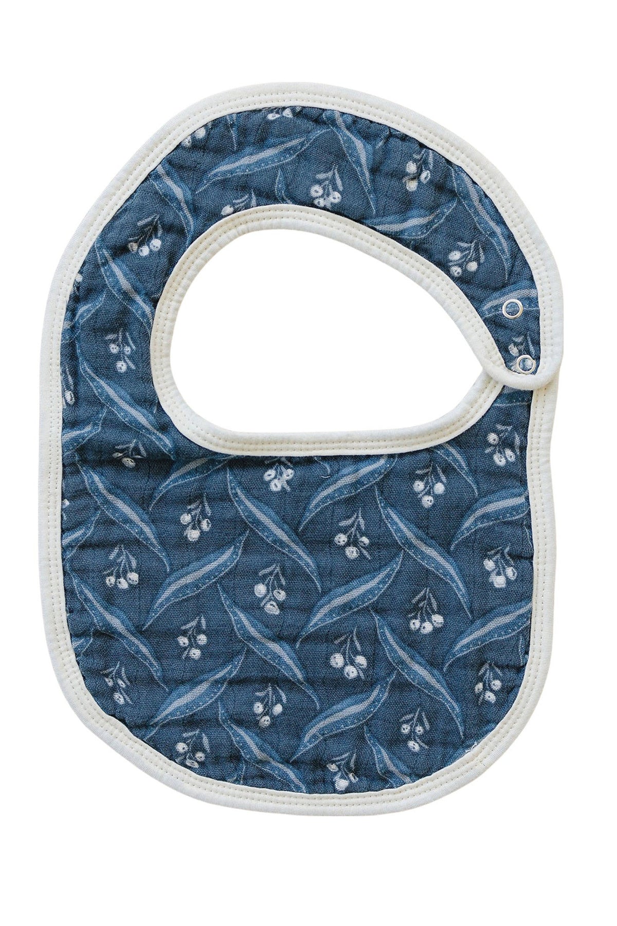 Navy muslin bib with white berry pattern, featuring a rounded shape and white trim, made from soft cotton.