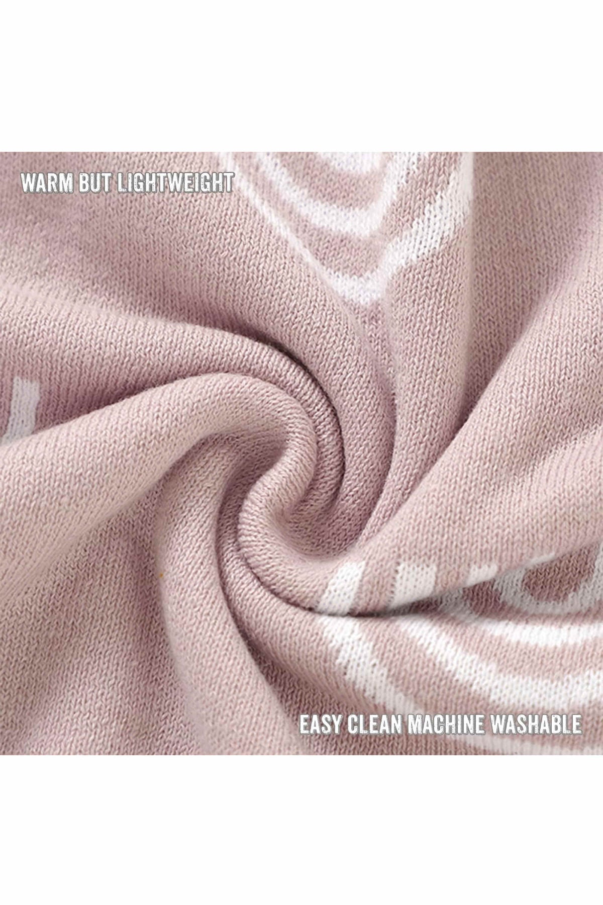 A close-up of a soft, pink knit fabric with white patterns, labeled warm but lightweight and easy clean machine washable.