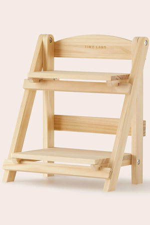 A natural wood play food storage rack features two shelves and a slanted design, perfect for organizing childrens kitchen accessories and toys.