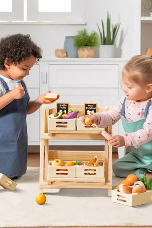Two children play with a wooden food storage rack, filled with colorful play fruits and vegetables. The setting features a bright, clean kitchen, promoting imaginative play and organization.