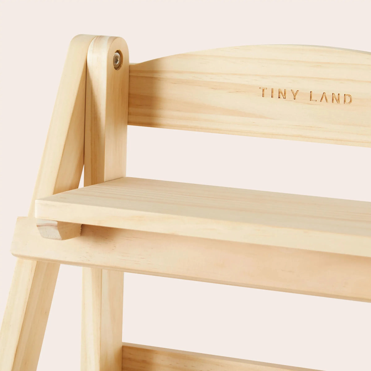Light-colored wooden storage rack with three shelves, featuring a natural finish and engraved TINY LAND logo, ideal for organizing childrens play food and accessories in a play kitchen setting.