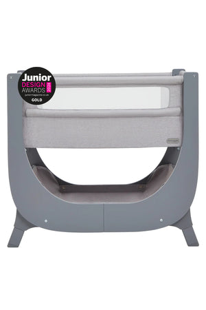 The Shnuggle Air Lite Bedside Bassinet features a sleek gray design with breathable mesh sides, designed for infants. It is height-adjustable and won a Junior Design Award Gold.