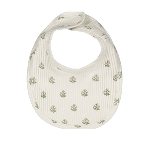 A cream cotton bib featuring a delicate floral print in green and soft pink, designed for infants.