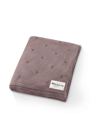 A folded, mauve pointelle knit blanket with a Bleu-La-La Organics label, crafted from organic cotton.