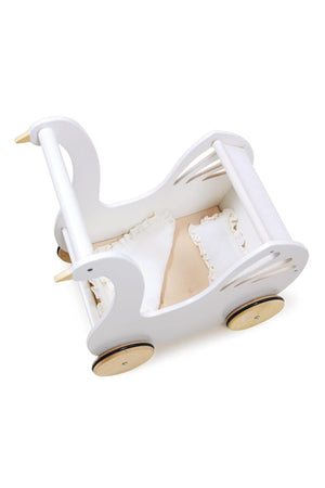 A white wooden baby carriage shaped like a swan features smooth natural wooden wheels, delicate cutout details, and a cozy interior with a blush mattress and muslin coverlet.