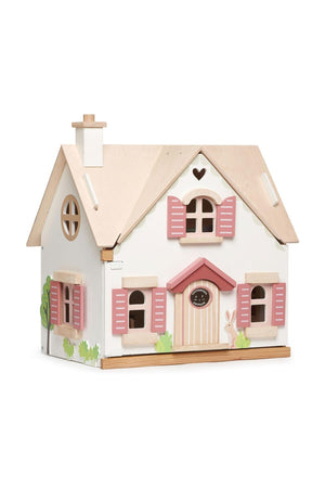 A charming wooden dollhouse with a natural wood roof, pink shutters, and whimsical details, perfect for imaginative play.