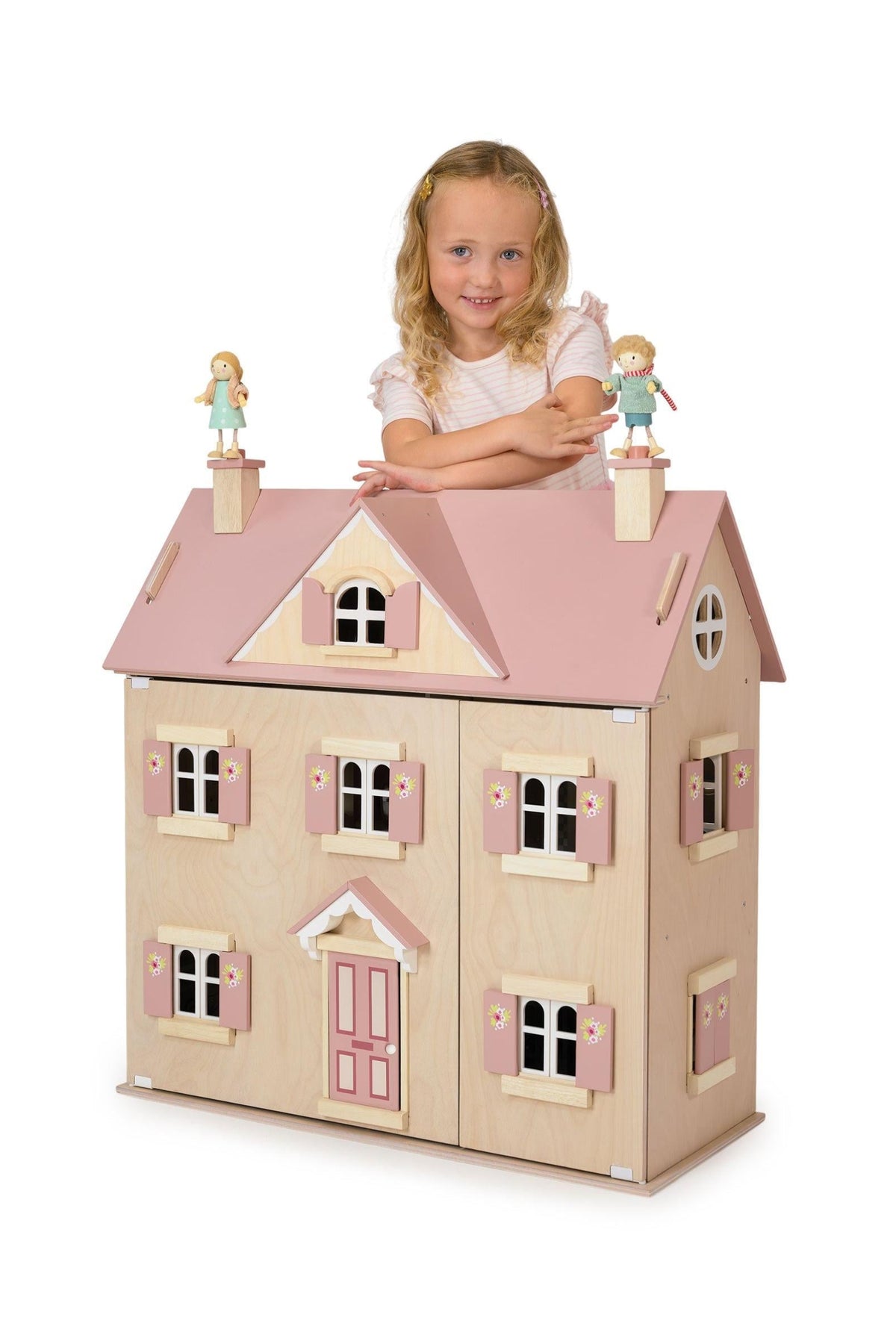 Child with a dollhouse and dolls on a white background