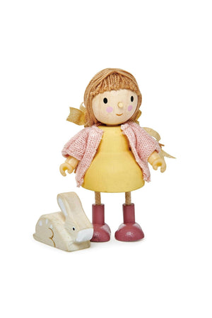 A wooden doll with a pink dress and knitted cardigan stands next to a small white rabbit figure.