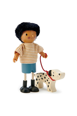 Wooden doll with black hair, striped shirt, blue skirt, holding a spotted dog on a red leash.