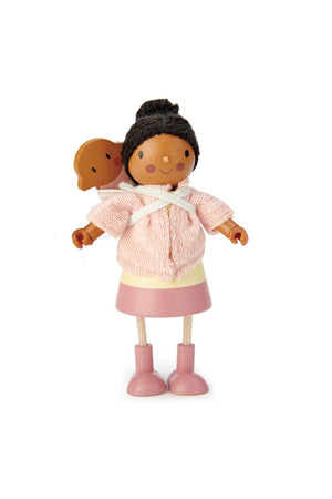 Wooden doll in pink knitted sweater, pink skirt, and boots, carrying a baby on her back.