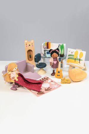 A colorful wooden dollhouse study furniture set featuring two dolls, a swivel chair, a couch, and an easel with a painting. The cozy scene encourages imaginative play for children.