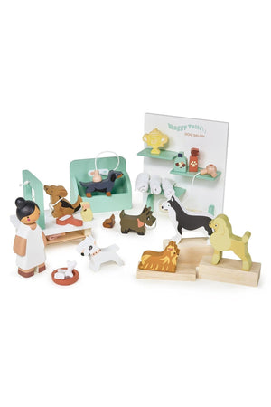 A colorful wooden dog grooming play set features a groomer, seven dog figures, and salon accessories, all designed for imaginative play. Ideal for children aged three and up.