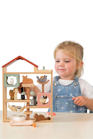 Child playing with a wooden toy structure on a white background