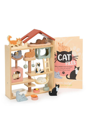 A colorful wooden cat hotel features multiple levels with playful cats and kittens. The set includes soft beds and a booklet titled Cat Files, designed for imaginative play.