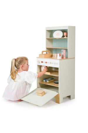 Child playing with a toy dishwasher on a white background