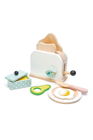 A wooden toaster set featuring two slices of bread, a wooden knife, a poached egg, and avocado slices, all in.