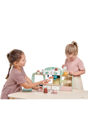 Two children play with the Tender Leaf Wooden Toys Bird’s Nest Café, featuring pastel colors and wooden accessories for imaginative.