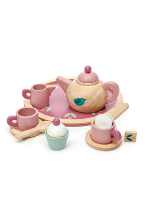 A wooden tea set by Tender Leaf featuring a pink and mint color scheme. It includes a teapot, cups, a milk jug, a cupcake, and a round tray, all crafted.