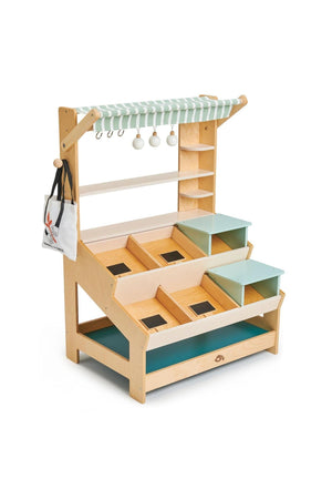 A wooden market stall with a striped canopy, featuring shelves and colorful mini platforms for imaginative play.