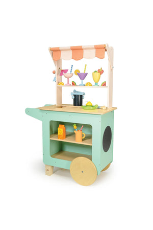 Colorful wooden drinks trolley with striped awning, featuring toy glasses, fruit, and accessories. Eco-friendly playset on wheels.