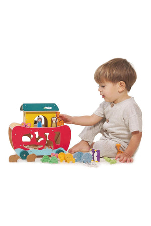 Child playing with a colorful wooden toy on a white background