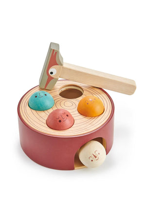 Colorful wooden hammer game featuring a tree trunk base with smiling balls. Designed for toddlers aged 18 months and older.