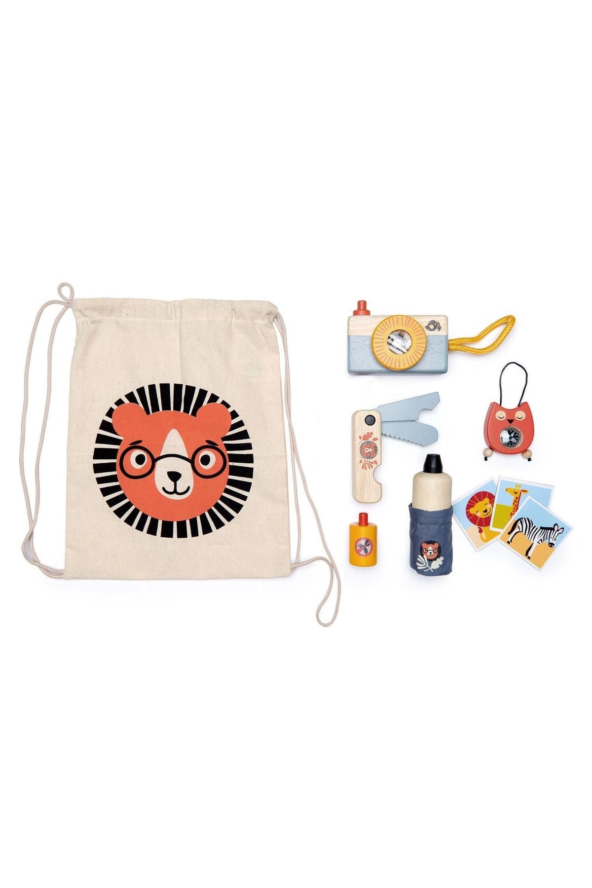 A beige drawstring bag features a lion graphic, surrounded by wooden safari adventure items including a camera, water bottle, and compass, all designed for imaginative play.