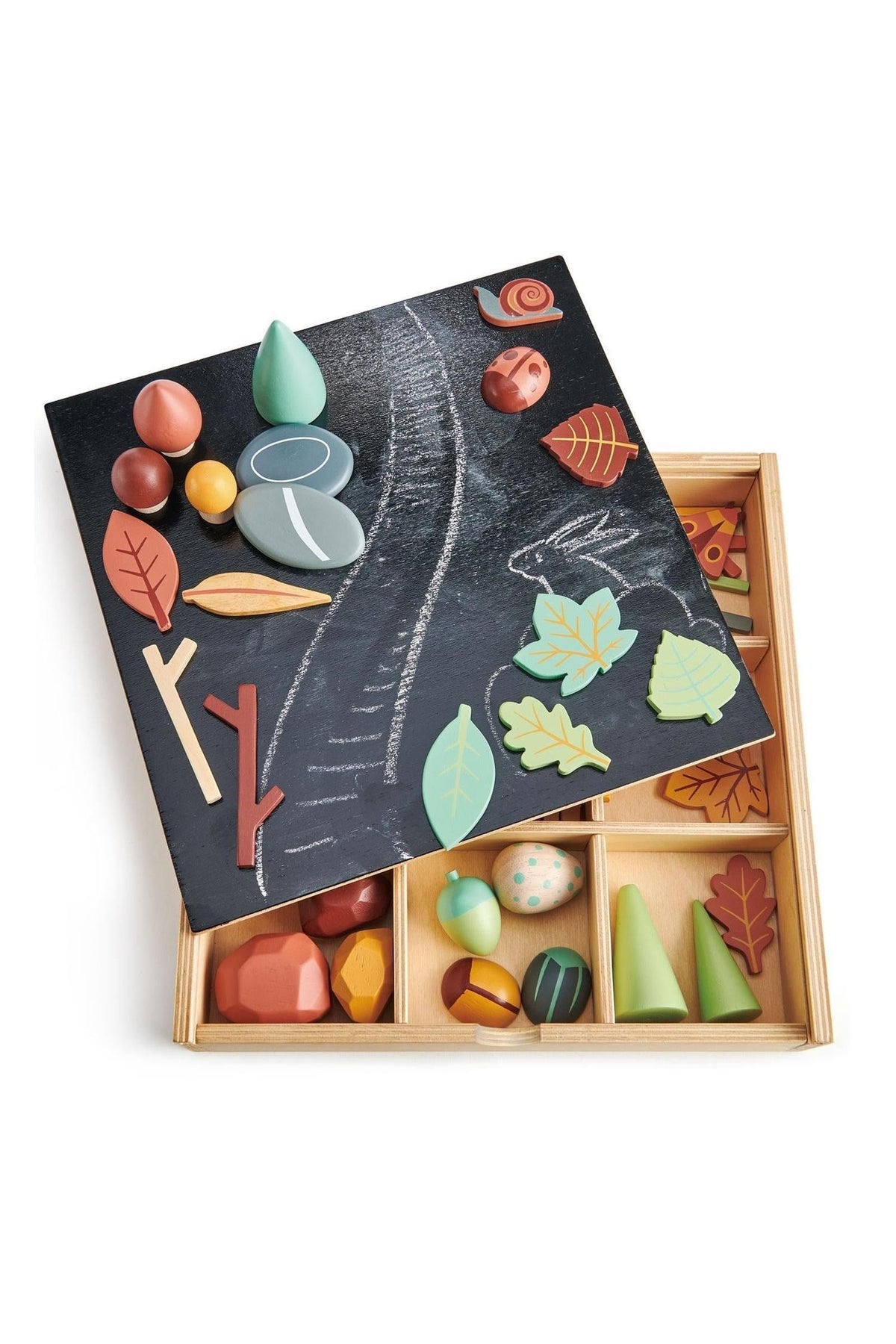 A wooden toy tray featuring a reversible chalkboard lid and colorful, nature-themed pieces including leaves, rocks, and acorns. The tray is crafted from sustainable materials, promoting creative play for children.