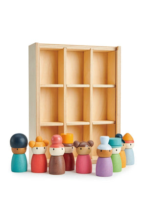 A collection of eight colorful wooden characters stands in front of a light wood display shelf with six compartments.
