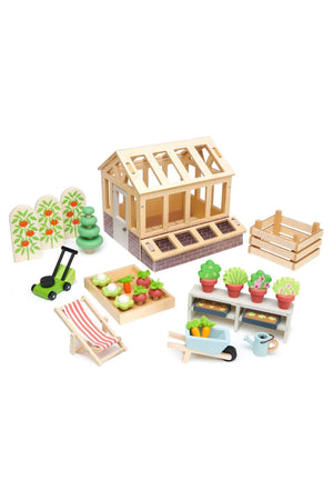 A colorful wooden greenhouse set featuring potted plants, gardening tools, and accessories. Made from sustainable materials, this Tender Leaf Toys set encourages imaginative play for children aged 3 and up.