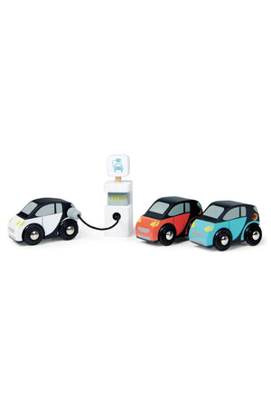 Three colorful electric smart cars in black, red, and blue are positioned near a charging station, showcasing their wooden construction and eco-friendly design, ideal for sustainable play.