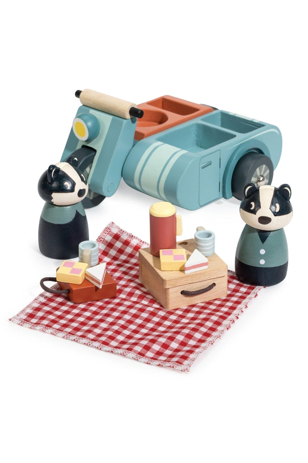 A charming wooden toy picnic set features two animal figures, a motorbike with a sidecar, and a picnic blanket with food items. The eco-friendly design is perfect for imaginative play.