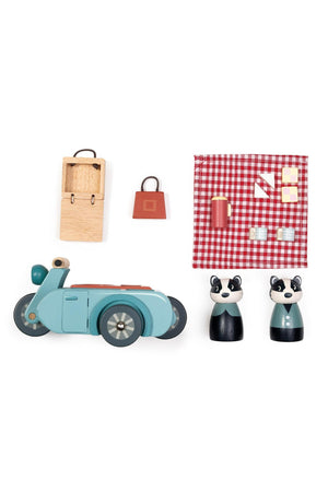A charming wooden motorbike in teal, accompanied by two panda figurines and a picnic set featuring a checkered blanket, basket, and food items. Perfect for imaginative play.