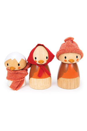 Three wooden bird figures with painted faces and orange accessories, featuring scarves and hats, on a white background.