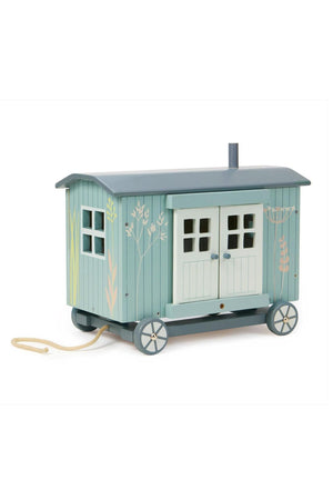 A charming blue shepherds hut toy features detailed floral illustrations and a functional door. Crafted from sustainable wood, its perfect for imaginative play, suitable for young children.