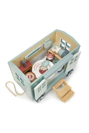 A colorful wooden shepherds hut toy features playful details like a teacup shower and thread spool chairs, designed for imaginative play. Ideal for eco-conscious families, it encourages creativity in children.