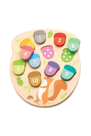 Colorful wooden acorn pieces are arranged on a natural wood base featuring a playful squirrel design. This eco-friendly toy from Tender Leaf Toys helps young children learn numbers and counting.