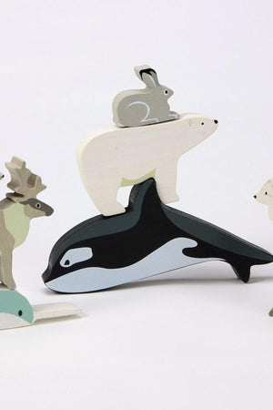 A stack of wooden polar animal toys includes a polar bear, snow hare, and orca, showcasing eco-friendly craftsmanship.