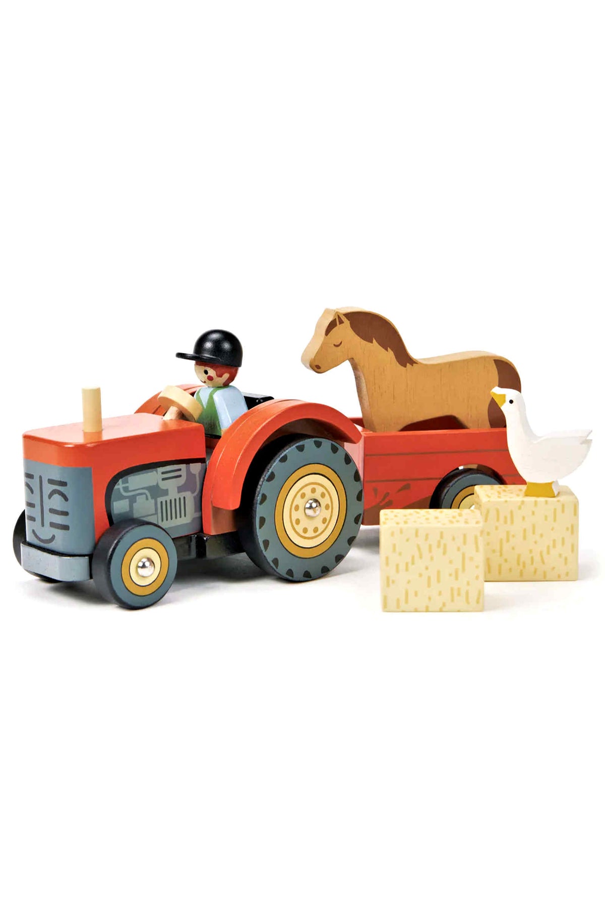 A vibrant red wooden tractor with a removable driver, featuring a horse and duck on a trailer, alongside hay bales.